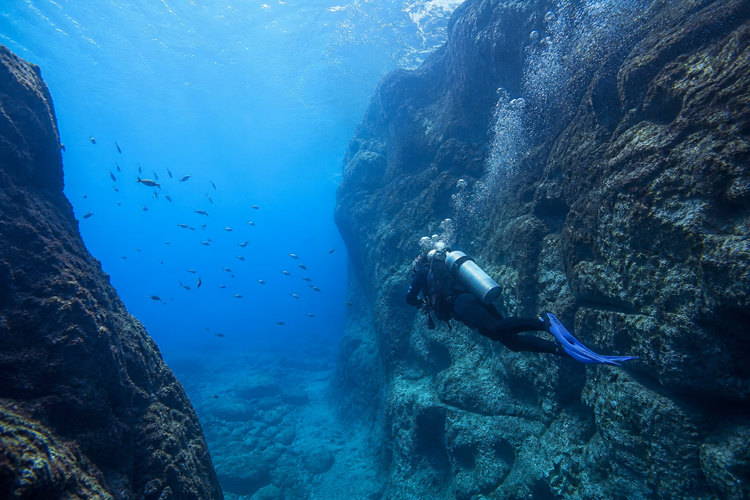 Diver exploring volcanic reefs off Madeira, Portugal