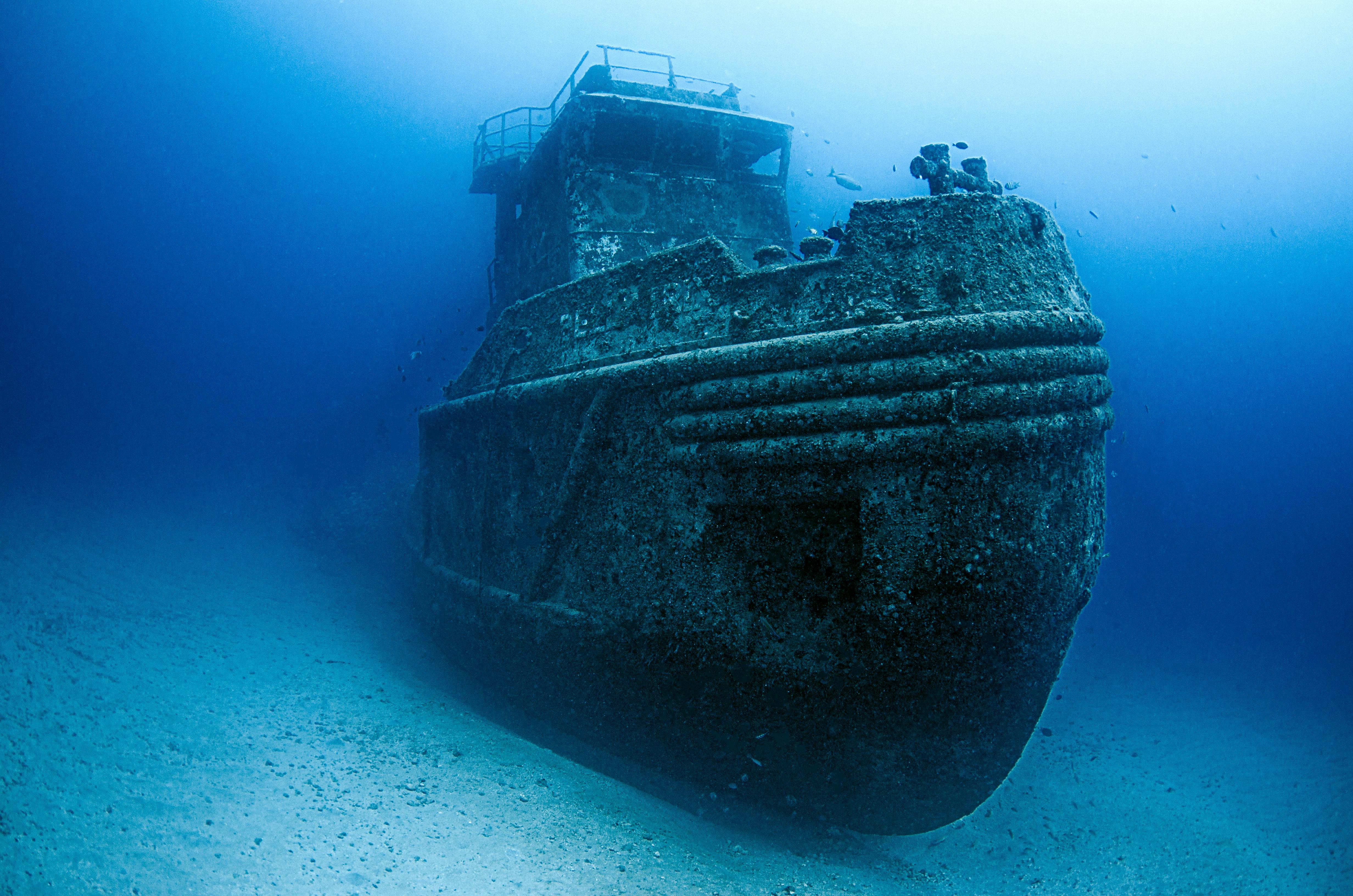 Divers exploring a sunken shipwreck