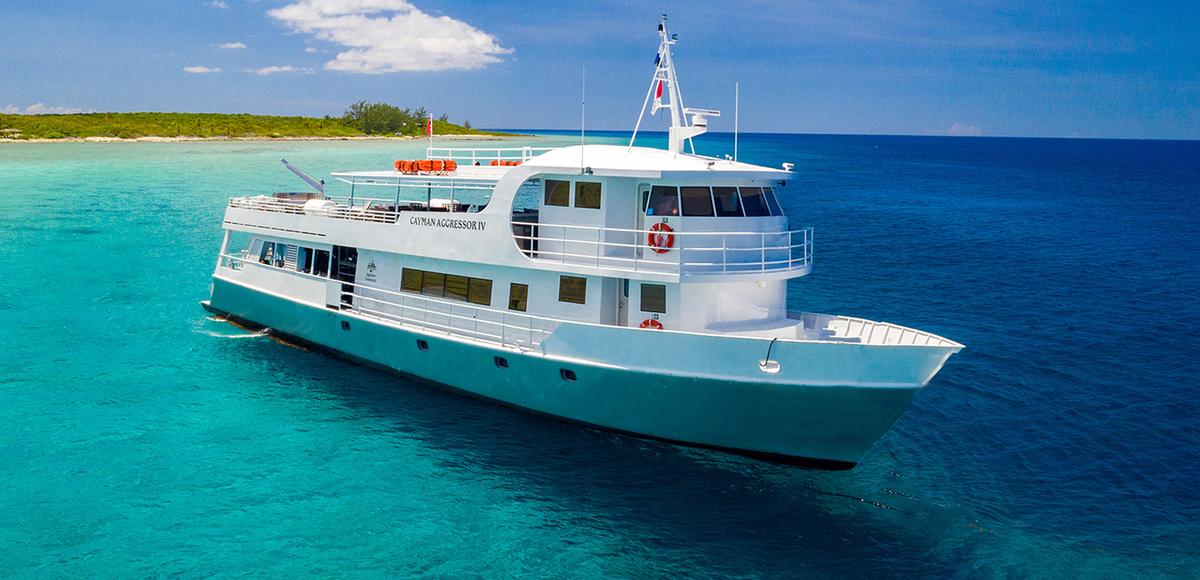 Cayman Aggressor IV liveaboard anchored in turquoise Cayman Islands water