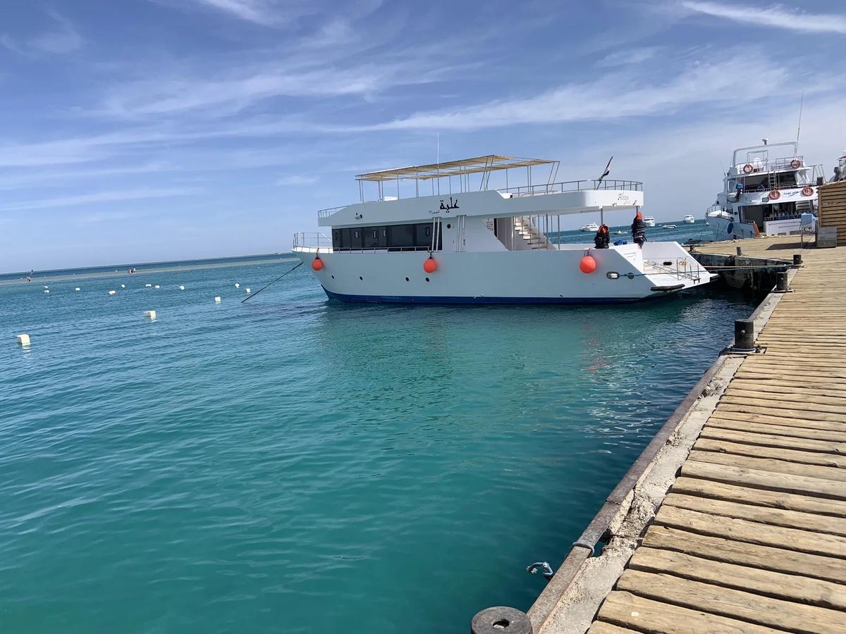Dive boat moored at a jetty on the Red Sea coast near Hurghada, Egypt